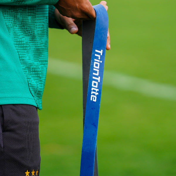 Bengaluru FC Player holding a blue TrionTotte Power Band